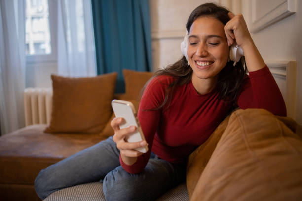istock Happy young woman using phone 1432973586
