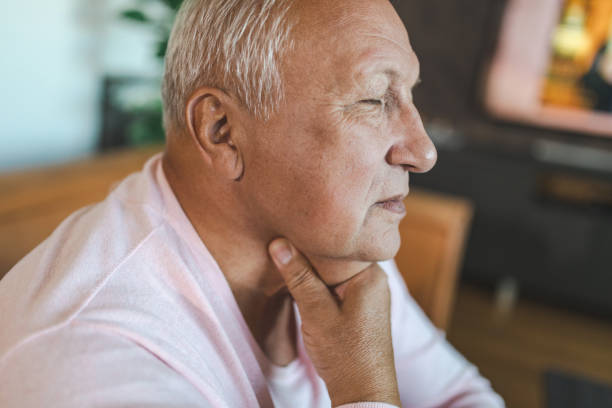 man with a sore throat - touching neck imagens e fotografias de stock