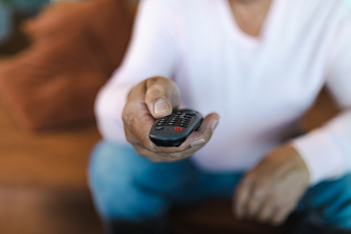 Mature man holding a tv remote