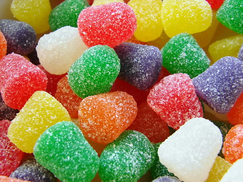 Macro shot of multicolored sugary gumdrops in a pile