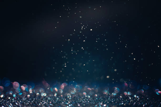 istock Defocused black glitter texture with iridescent bokeh and snow in the dark 1432974852