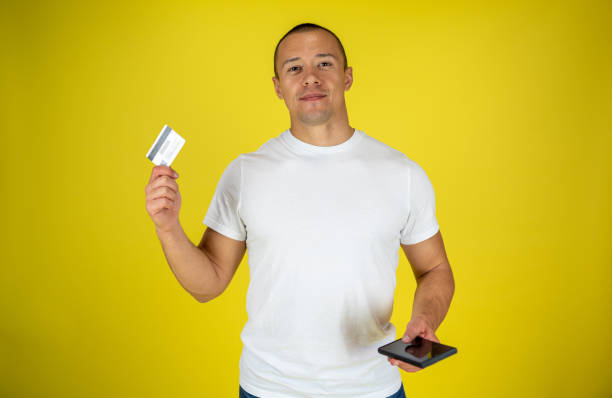 istock A man is standing with a credit card and a phone 1432976245