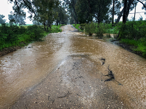 Back road in rural Victoria during a heavy rain event with water across the road