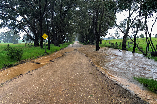 Back road in rural Victoria during a heavy rain event with water across the road