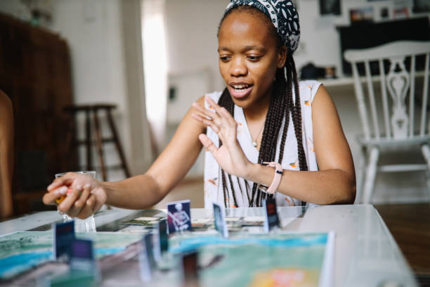 istock group of friends playing a boardgame at home 1432981249