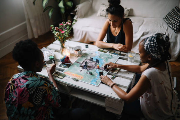 istock group of friends playing a boardgame at home 1432981273