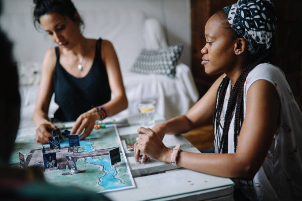 istock group of friends playing a boardgame at home 1432981375