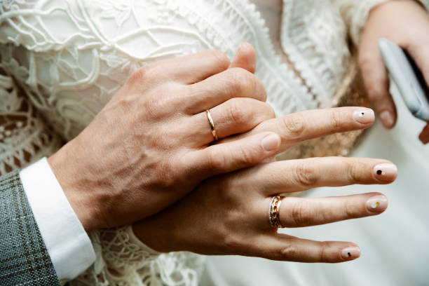 istock Newly wed couple's hands with wedding rings 1432981518