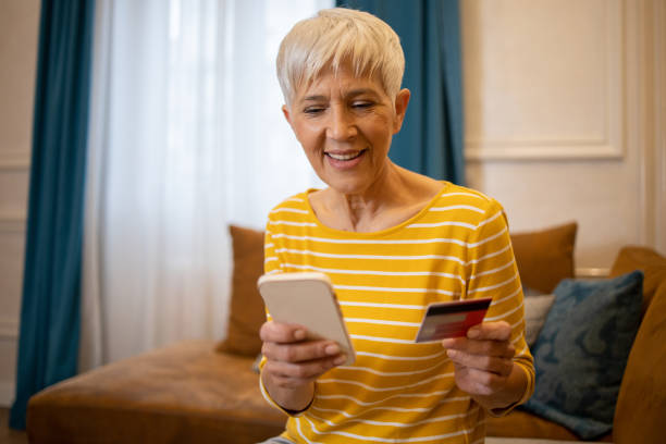 istock Cheerful  woman doing online shopping 1432982723