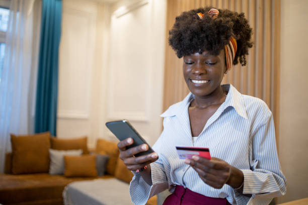 istock Cheerful  woman doing online shopping 1432982813