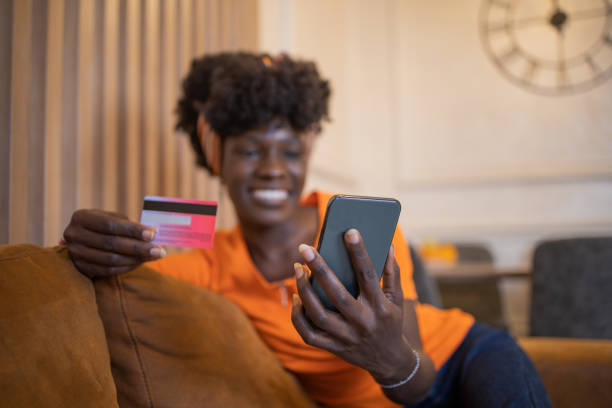 istock Cheerful  woman doing online shopping 1432982848