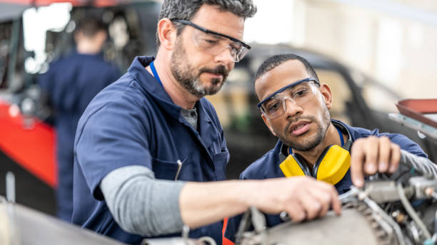 istock Aviation mechanics checking helicopter turbine and using work tool, close up 1432986759