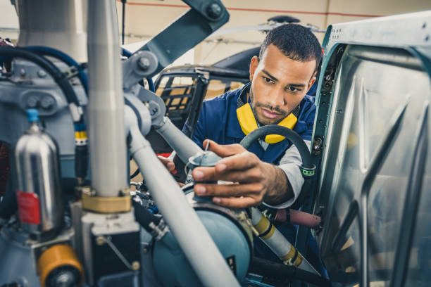 istock Aviation mechanic in protective headphones and uniform examining helicopter engine, close up 1432986768