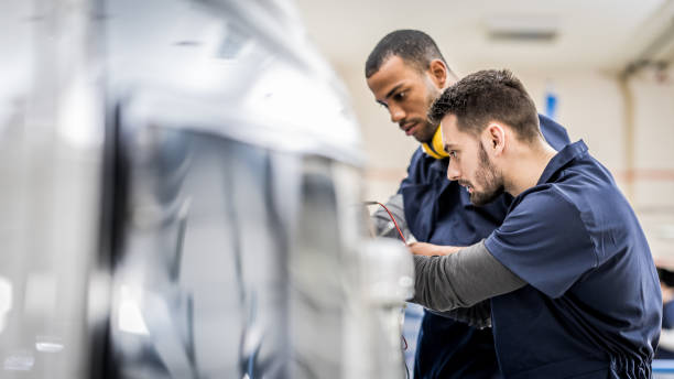 istock Young airplane engineers coworking in helicopter hangar 1432986773