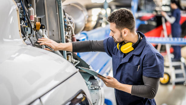 istock Young handsome male aviation mechanic checking helicopter engine 1432986791