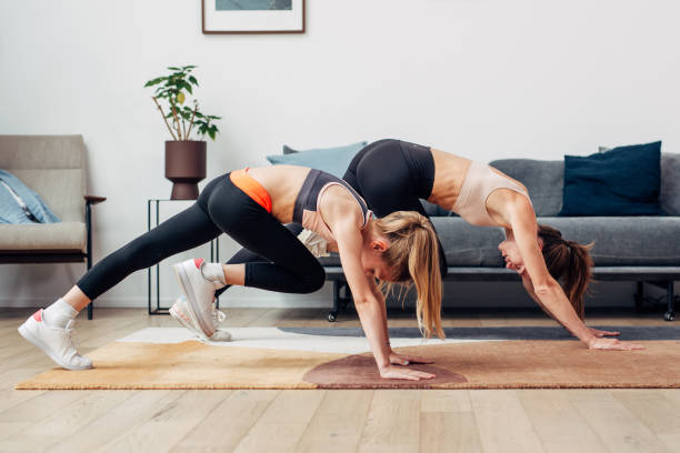 istock Girls doing abs exercise mountain climbers exercise at home. 1432986925