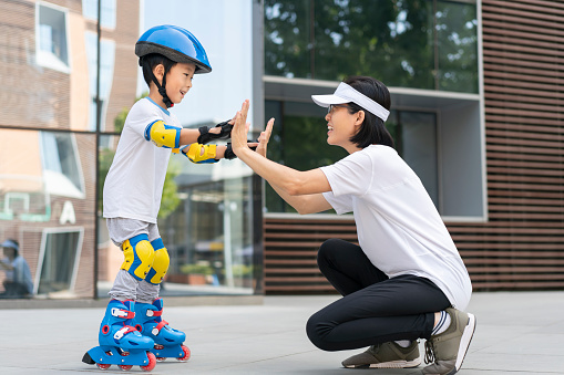 Mom and baby learn roller skating together