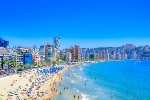 Summer afternoon with people relaxing on the beach, Benidorm, Spain.