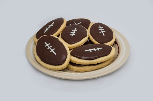 American football shape cookies on white background