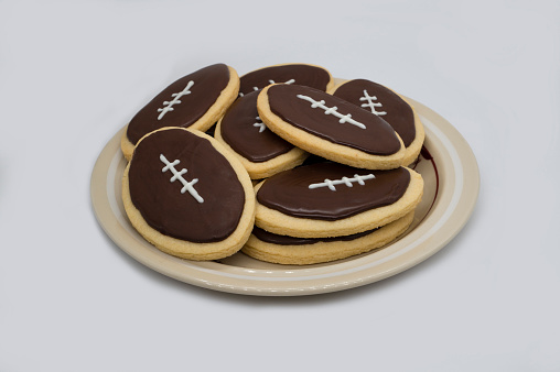 Super Bowl party cookies on plate. Home baked cookies on white background