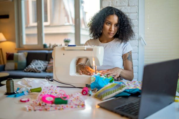 istock A young woman is learning sewing on machine at home 1432993829