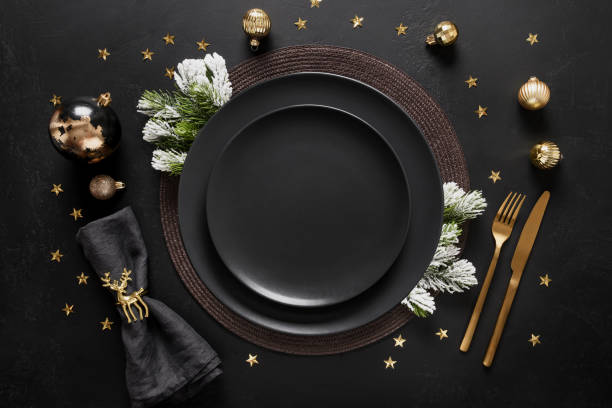 istock New Year black table setting with elegant golden decorations on black table. View from above. 1432993845