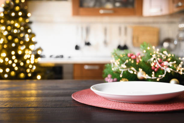 istock Wooden tabletop with cutting board and Christmas decoration on blurred modern kitchen. 1432993857