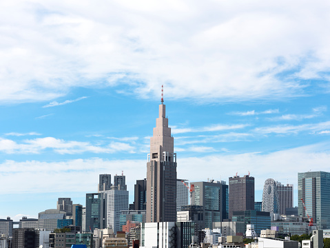 View of Tokyo Shinjuku skyline against blue sky with copy space.