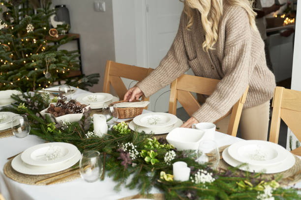 Unrecognizable caucasian women preparing table for Christmas Eve