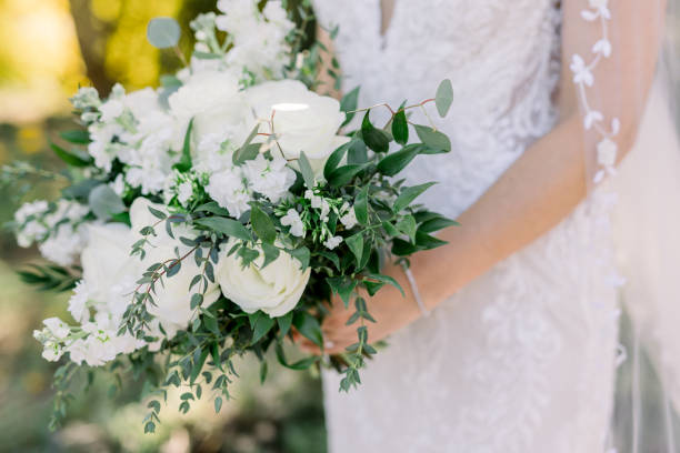 istock Bride holding bridal bouquet with white flowers and greenery 1433001531