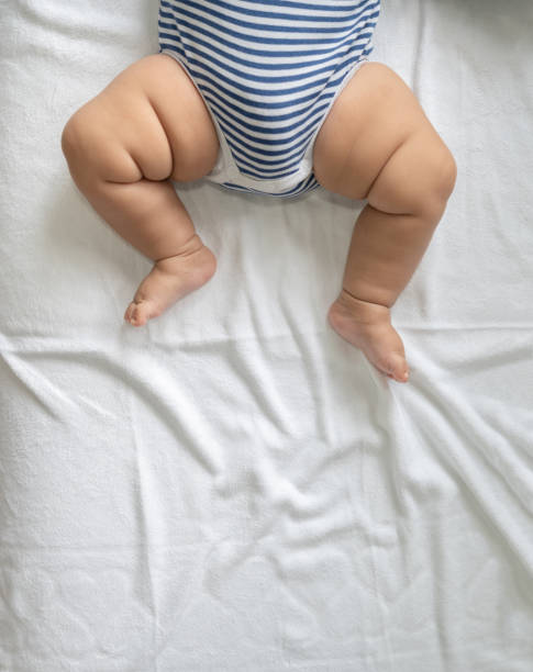 istock Baby feet in white bed. 1433005372