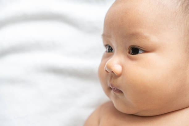 istock A newborn baby who opens his eyes and looks sideways 1433006325