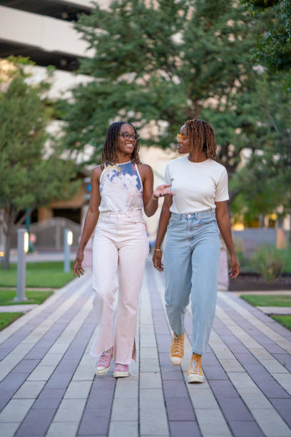 istock African american twins walking in a public park 1433010337