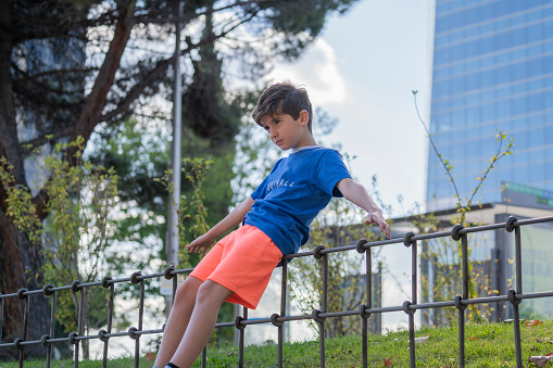 child in a park practicing balance in Madrid downtown centre.