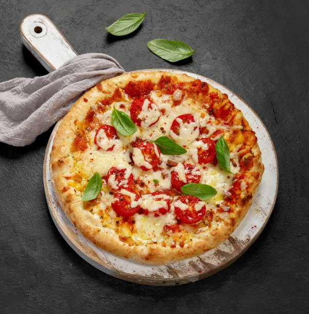 Freshly baked pizza on dark background.