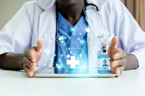 African American man doctor with medical icons on tablet analysis technology equipment medicine healthy, Medical doctor technology and healthcare concept.
