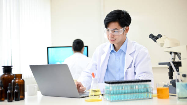 istock Intelligent and handsome young Asian male scientist working in his office, using laptop. 1433015797