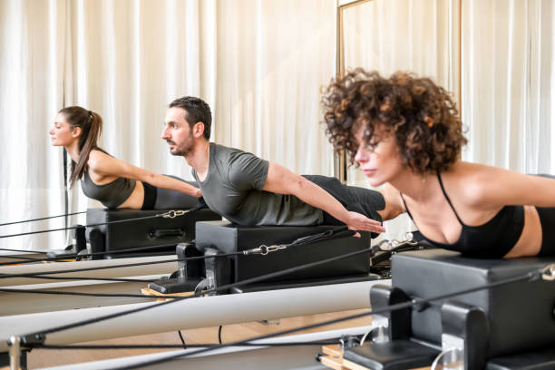 istock Man and woman doing exercise on pilates reformer 1433016812
