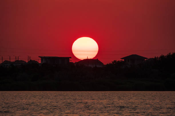 The sun goes down over a lake. Dramatic Sunset Sky