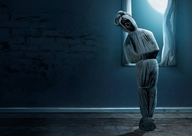 istock Pocong is covered with a white linen shroud standing 1433020486