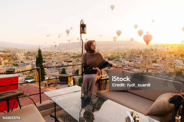 Young Muslim Woman Looking View Of Hot Air Balloon In Cappadocia Stock Photo - Download Image Now