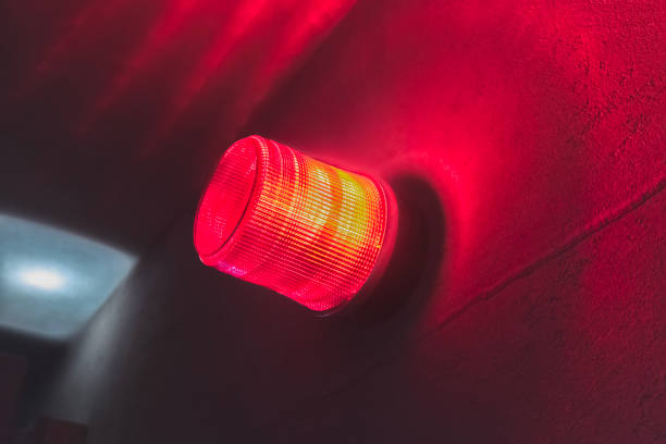 wall mounted red warning light, spinning and blinking, air raid siren - air raid imagens e fotografias de stock