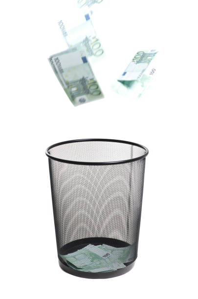 istock money flying into the trash 1433032305