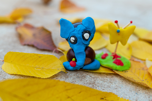 Children hand made autumn decoration from plasticine, elephant from chestnuts. beautiful animal