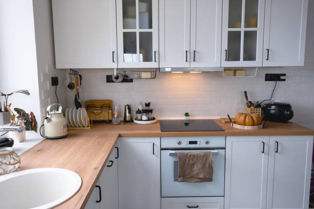 istock White cozy kitchen in Scandi loft style. Home interior, dining room design, oven, hob, table, kitchen furniture 1433033571