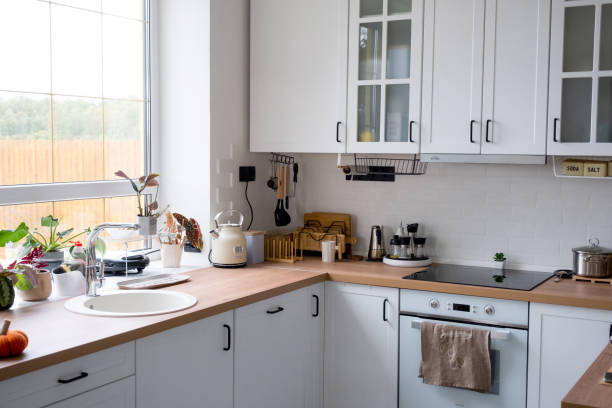 istock White cozy kitchen in Scandi loft style. Home interior, dining room design, oven, hob, table, kitchen furniture 1433033572