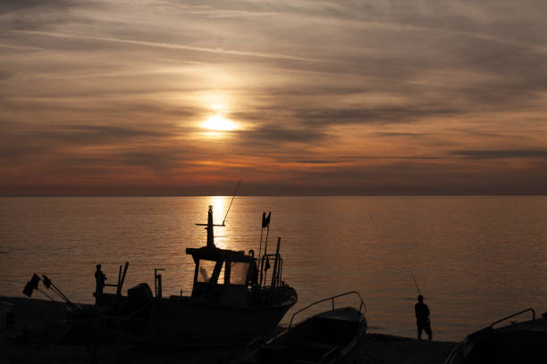 istock fishing boat at sunset 1433033836