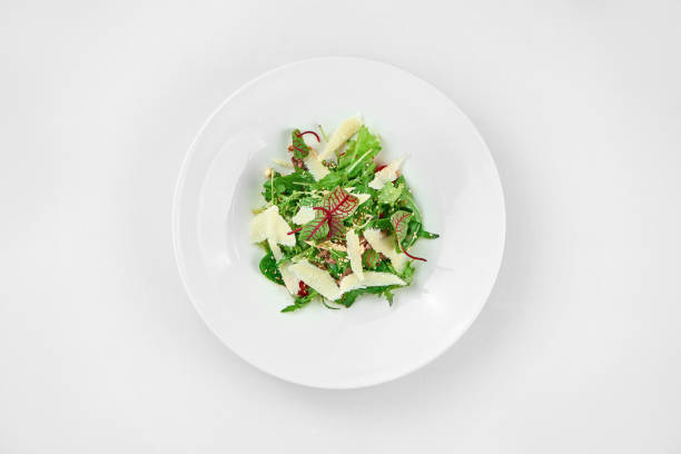 Salad with roast beef and parmesan on a white plate. Close-up. Selective focus