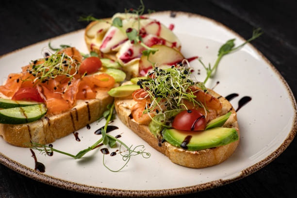 istock sandwich with salmon, avocado, tomato and cheese. healthy breakfast. 1433035014