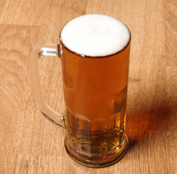 istock Single beer glass on wooden table 1433035351